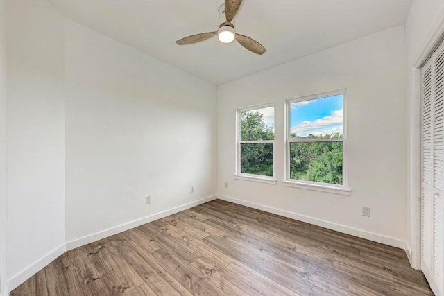 unfurnished bedroom with hardwood / wood-style flooring, a closet, and ceiling fan