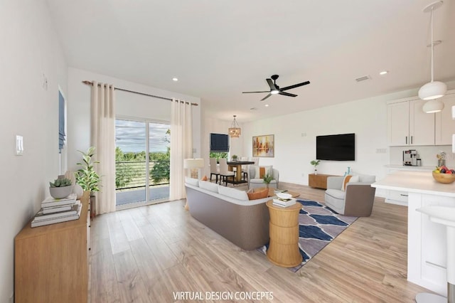 living room with ceiling fan and light hardwood / wood-style flooring