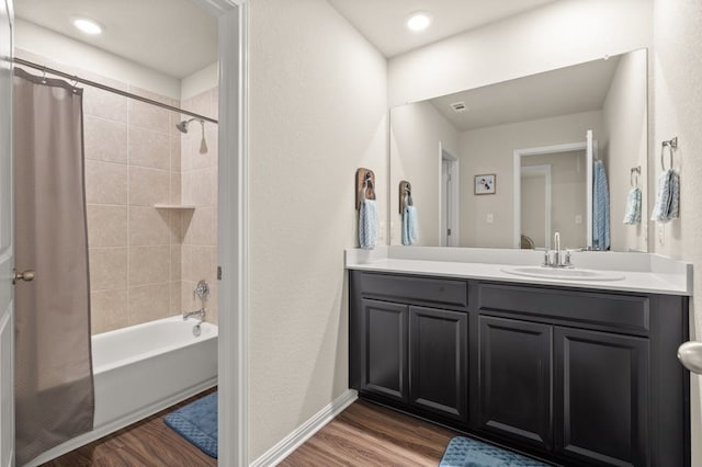 bathroom featuring wood-type flooring, shower / bath combo, and vanity