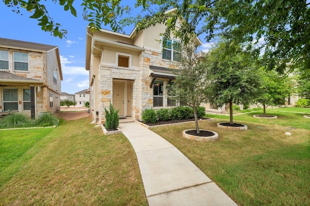 781 Lone Peak Way, Dripping Springs, TX 78620 - view of front of home with stucco siding, stone siding, and a front yard