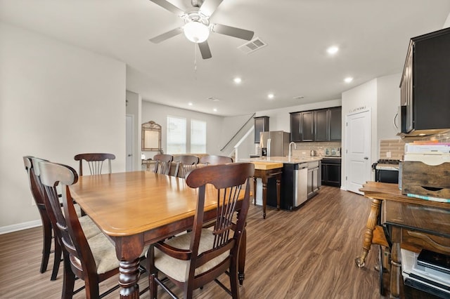 dining space featuring dark hardwood / wood-style floors and ceiling fan