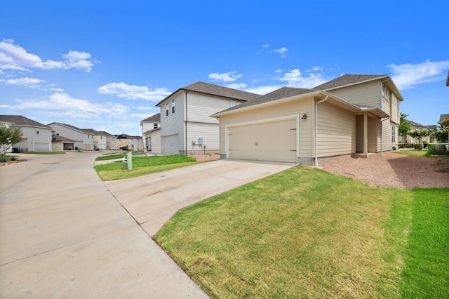 view of front of property featuring a garage and a front yard