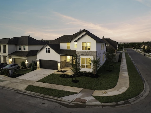 view of front of home with a garage and a yard