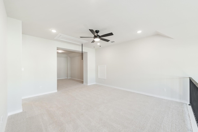 carpeted spare room featuring ceiling fan