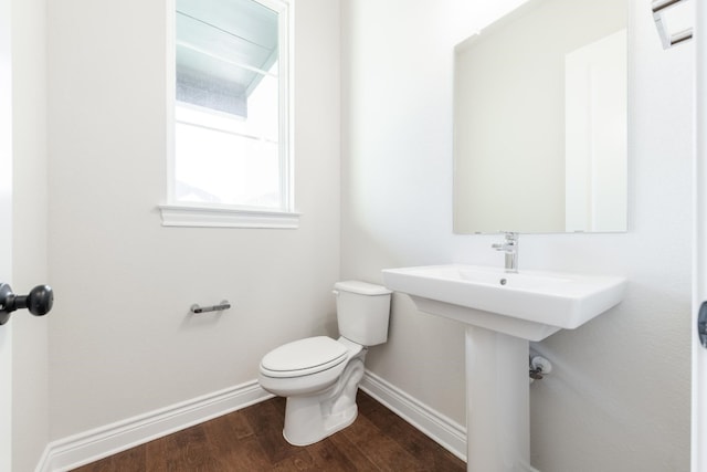 bathroom featuring wood-type flooring and toilet