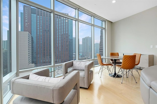 living room with expansive windows and light wood-type flooring