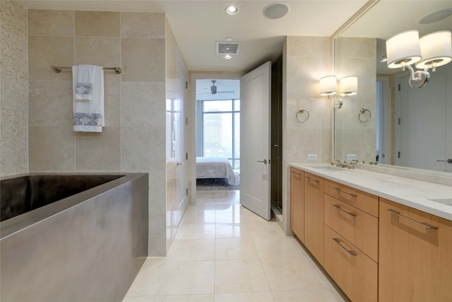 bathroom featuring tile patterned floors, vanity, and tile walls