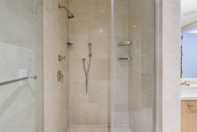 bathroom featuring vanity and tiled shower