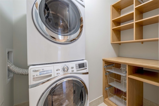 laundry room with stacked washer / dryer