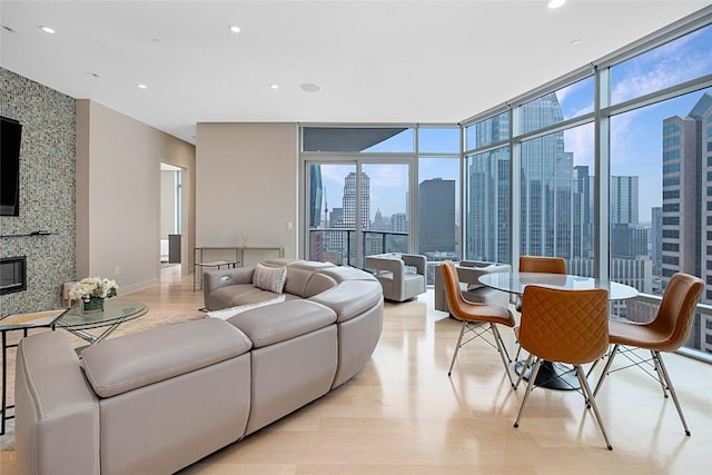 living room featuring a healthy amount of sunlight, floor to ceiling windows, and a fireplace