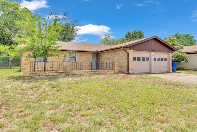 single story home featuring a garage and a front lawn