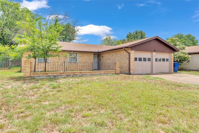 ranch-style house featuring a garage and a front lawn