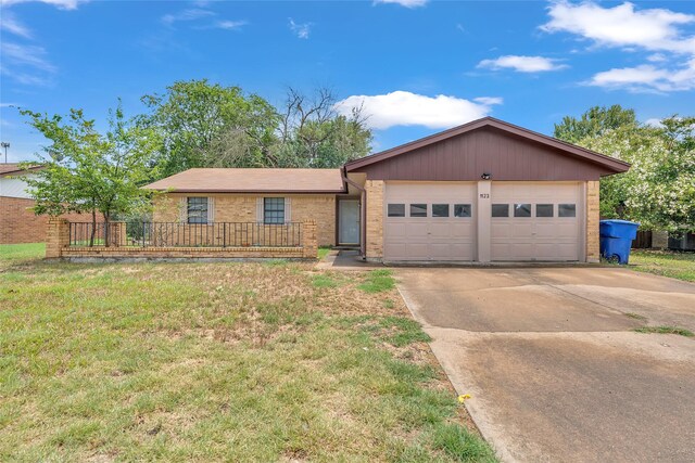 ranch-style house featuring a garage and a front lawn