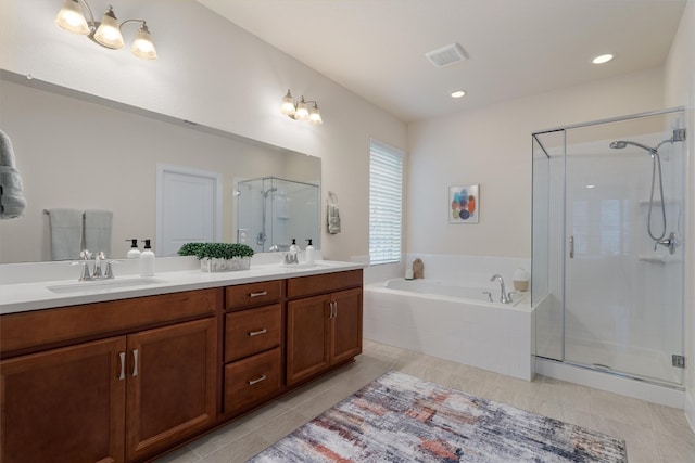 bathroom featuring tile patterned flooring, vanity, and separate shower and tub