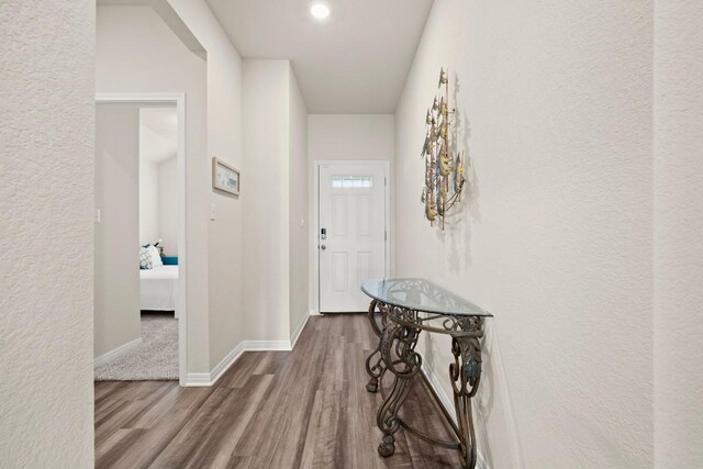 hallway with wood-type flooring