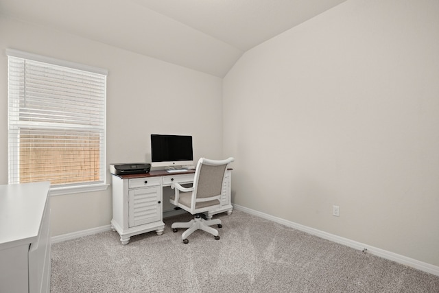 office space featuring vaulted ceiling and light colored carpet