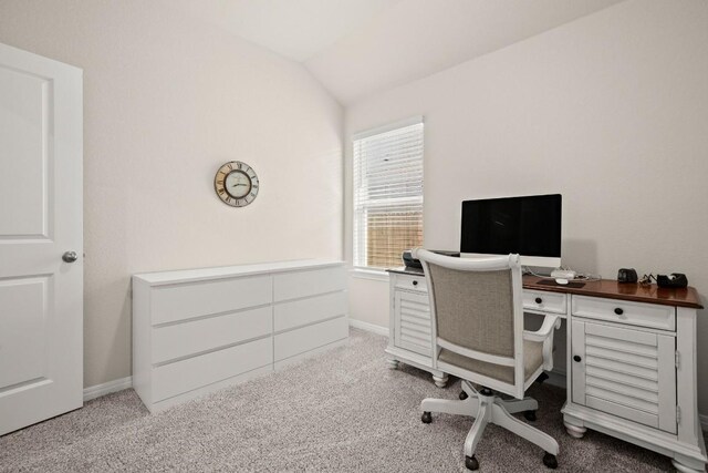 carpeted office featuring vaulted ceiling