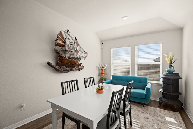 dining space featuring vaulted ceiling and hardwood / wood-style floors