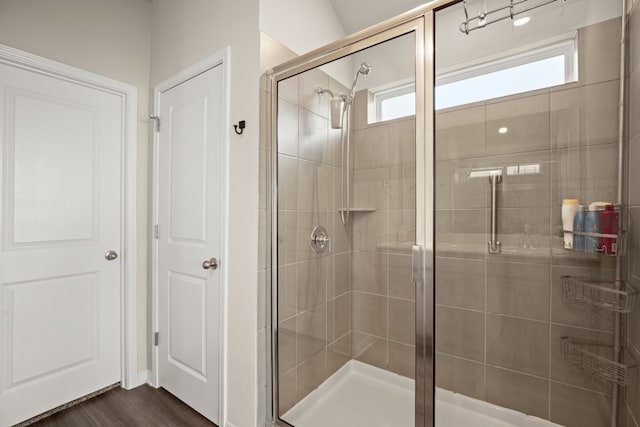 bathroom featuring walk in shower and hardwood / wood-style flooring