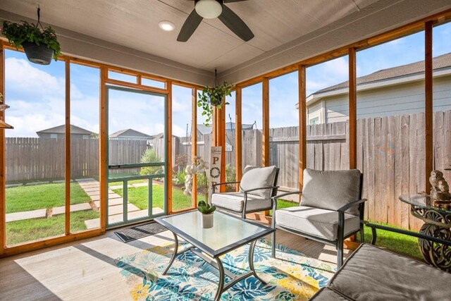 unfurnished sunroom with a healthy amount of sunlight and ceiling fan