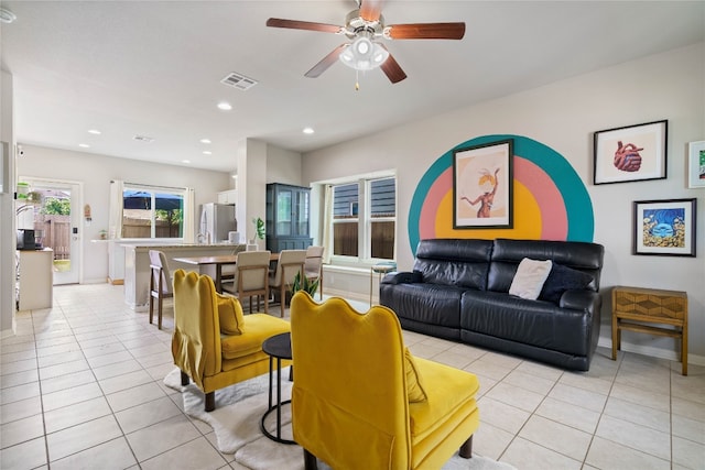 tiled living room with ceiling fan