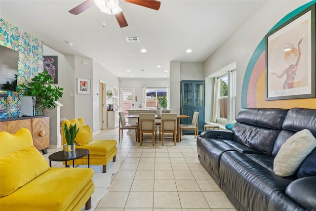 living room featuring light tile patterned flooring and ceiling fan