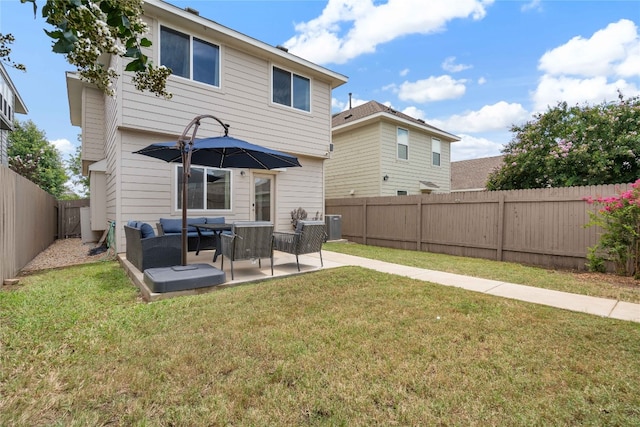 rear view of house with a patio and a lawn