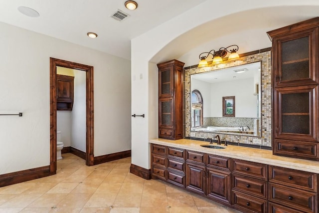 226 Canyon Turn Trl, Austin, TX 78734 - bathroom featuring baseboards, toilet, a bath, tile patterned flooring, and vanity