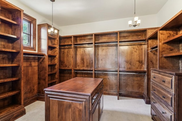 spacious closet featuring light colored carpet and a chandelier