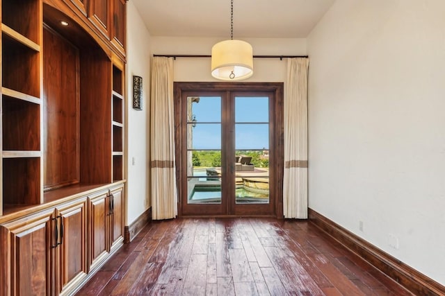 doorway with dark wood-style flooring, baseboards, and french doors