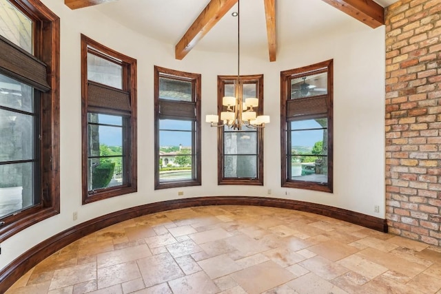 interior space with an inviting chandelier, a healthy amount of sunlight, and beam ceiling