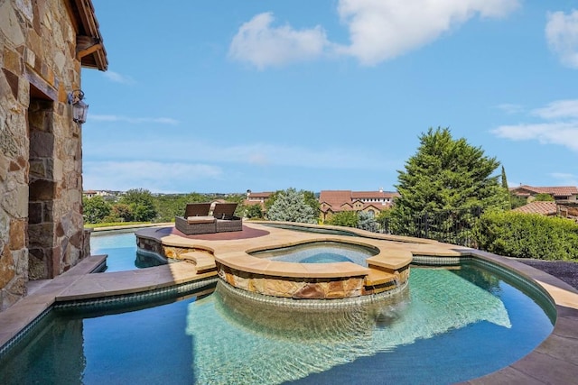 view of swimming pool featuring a pool with connected hot tub