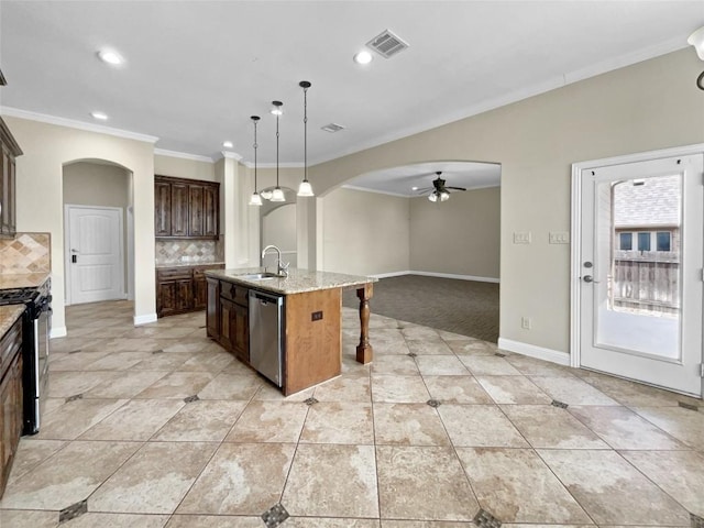 kitchen with sink, decorative light fixtures, a center island with sink, stainless steel appliances, and light stone countertops