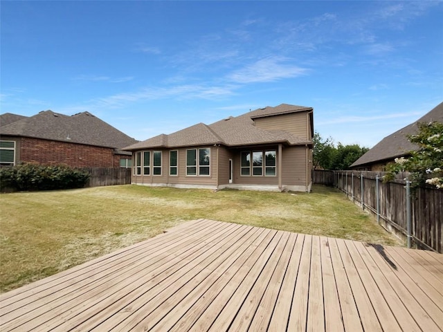 exterior space with a wooden deck and a lawn