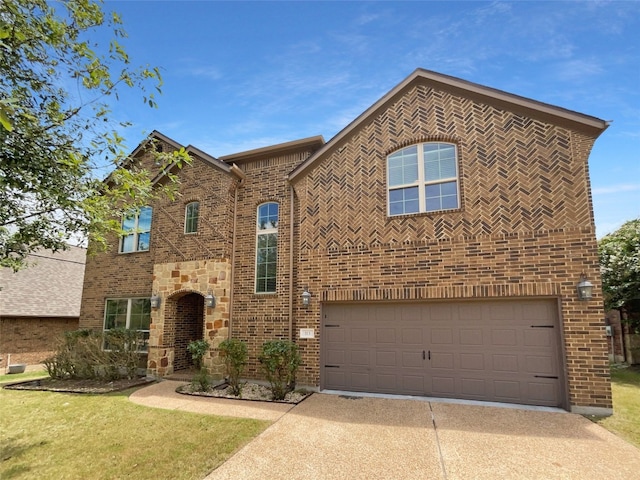 view of front of home with a garage and a front lawn