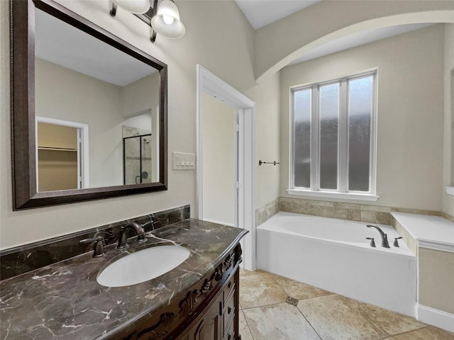 bathroom featuring vanity, tile patterned floors, and a tub