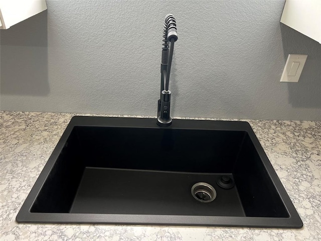 room details featuring light countertops and a sink