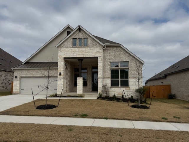 view of front of property featuring a garage and a front yard