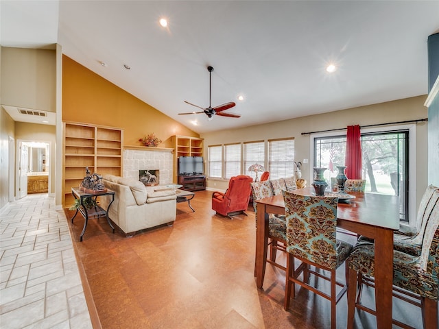 dining room featuring a fireplace, high vaulted ceiling, built in features, and ceiling fan