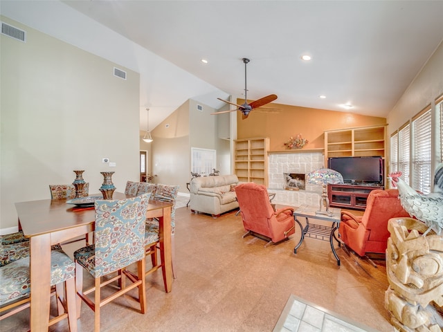 living room with ceiling fan, light carpet, lofted ceiling, and a fireplace