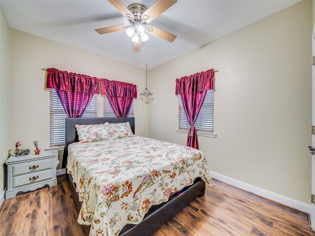 bedroom featuring ceiling fan and dark hardwood / wood-style floors