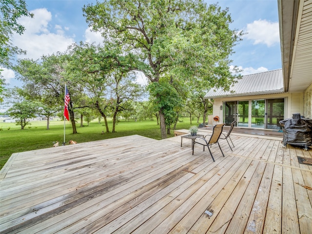 wooden deck featuring a yard