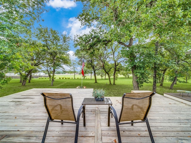 wooden deck featuring a lawn