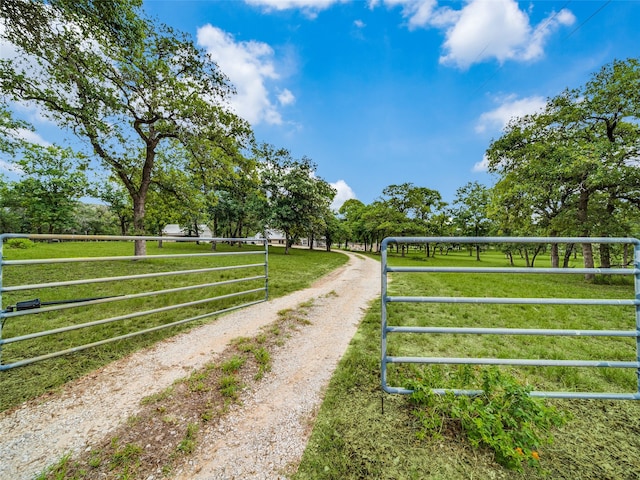 view of gate featuring a rural view and a yard