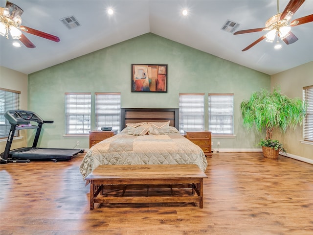 bedroom with high vaulted ceiling, ceiling fan, wood-type flooring, and multiple windows