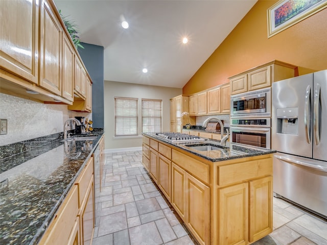 kitchen featuring sink, an island with sink, appliances with stainless steel finishes, and light brown cabinets