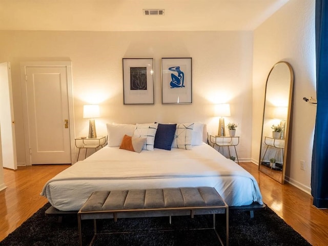 bedroom with hardwood / wood-style floors