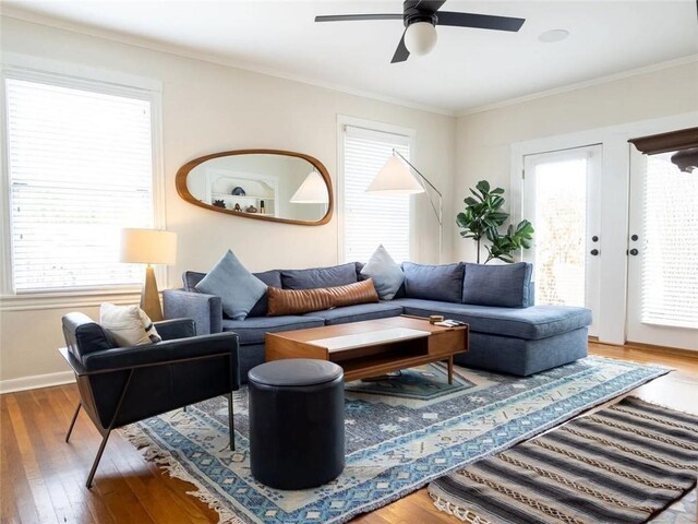 living room featuring crown molding, ceiling fan, and wood-type flooring