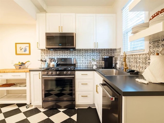 kitchen with decorative backsplash, range with gas cooktop, dishwashing machine, and light tile patterned floors