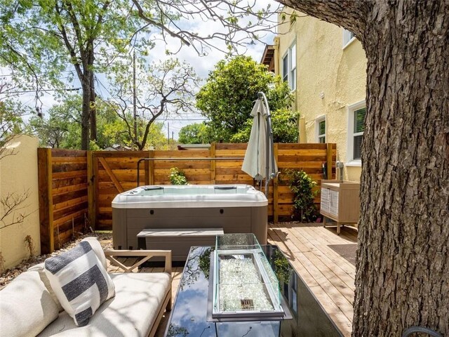 view of patio with a hot tub and a wooden deck